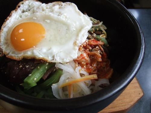 Under that glimmering, shimmering egg lies a treasure trove of vegetable and meat delight!