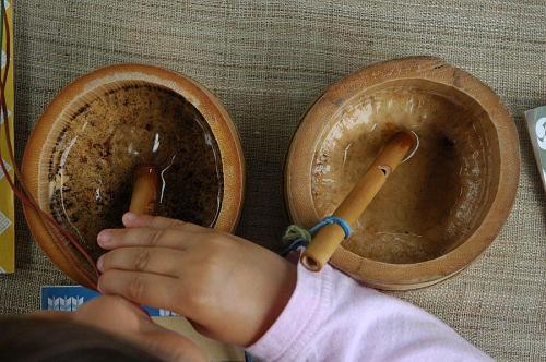 Blow the bamboo whistle into a shallow dish of water, and it sounds like a baby bird!