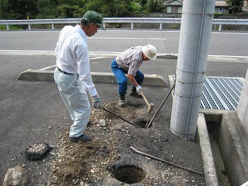 Digging post holes in the sandy, rocky soil - 50cm deep