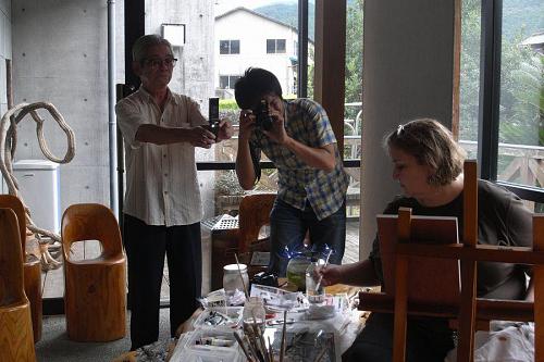 A reporter from the paper and another fan taking pictures of Liz at work in Michi no Eki.