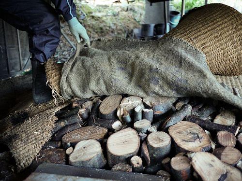 Stacked logs and straw mats